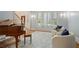 Cozy living room area features plush seating, a piano, and bright windows for a warm, inviting atmosphere at 9985 High Falls Pointe, Johns Creek, GA 30022