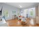 Large living room with hardwood floors, entertainment center, a ceiling fan, and natural light at 9985 High Falls Pointe, Johns Creek, GA 30022