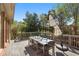 Outdoor deck featuring a dining table, chairs and umbrella with beautiful views of the surrounding trees at 9985 High Falls Pointe, Johns Creek, GA 30022