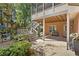View of the backyard patio with stairs leading to a screened in porch and an open view of the yard at 9985 High Falls Pointe, Johns Creek, GA 30022