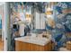Charming powder room showcasing blue tiger wallpaper, a modern vanity, and decorative sconces at 9985 High Falls Pointe, Johns Creek, GA 30022