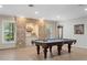 Recreation room featuring a pool table, tile floors, stone wall, recessed lighting, and several windows at 9985 High Falls Pointe, Johns Creek, GA 30022