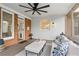 Cozy screened porch features a ceiling fan and comfortable seating area with decorative pillows and a stylish area rug at 9985 High Falls Pointe, Johns Creek, GA 30022