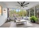 Relaxing screened porch with comfortable seating and a view of the backyard at 9985 High Falls Pointe, Johns Creek, GA 30022
