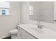 This bathroom features a white vanity, a toilet, and a shower-tub combo at 13917 Homer Lane, Covington, GA 30014