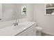 This bathroom features a white vanity, a toilet, and a shower-tub combo at 13917 Homer Lane, Covington, GA 30014