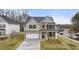 Beautiful two-story home featuring a two-car garage, a stone-accented entrance, and a well-manicured lawn at 13917 Homer Lane, Covington, GA 30014
