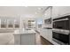 Bright kitchen featuring a large island, stainless steel appliances, and dining area view at 13917 Homer Lane, Covington, GA 30014