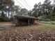 View of a brick home with a covered back patio surrounded by natural landscape at 2369 Christian Cir, Covington, GA 30016