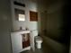 Modest bathroom features a vanity, toilet, and a bathtub at 2369 Christian Cir, Covington, GA 30016