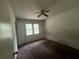 Carpeted bedroom with a ceiling fan, window, and doorway at 2369 Christian Cir, Covington, GA 30016