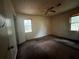 Spacious bedroom with ceiling fan and natural light from two windows at 2369 Christian Cir, Covington, GA 30016