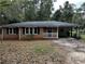 Charming brick ranch-style home with a covered carport and mature trees at 2369 Christian Cir, Covington, GA 30016