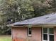 Close-up of a house roof with visible repairs and satellite dishes attached at 2369 Christian Cir, Covington, GA 30016