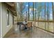 Back deck boasts a table, chairs, and views of the surrounding trees and nature at 3696 Suwanee Creek Ct, Suwanee, GA 30024