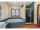 Bright bathroom features a tub with blue tile, a window, and a standing shower at 3696 Suwanee Creek Ct, Suwanee, GA 30024