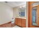 Bathroom featuring a mirror, vanity, toilet, and wood-look flooring at 3696 Suwanee Creek Ct, Suwanee, GA 30024