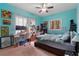 Comfortable bedroom with turquoise walls, a window with natural light, and a ceiling fan at 3696 Suwanee Creek Ct, Suwanee, GA 30024