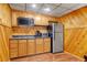 Kitchenette with stainless appliances and wooden paneled walls at 3696 Suwanee Creek Ct, Suwanee, GA 30024