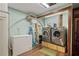 Laundry room with washer, dryer, deep freezer, and wood-look floors at 3696 Suwanee Creek Ct, Suwanee, GA 30024