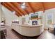 Cozy living room with a stone fireplace, wooden ceilings, and lots of natural light at 3696 Suwanee Creek Ct, Suwanee, GA 30024