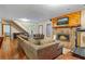 Cozy living room featuring wood floors, stone fireplace, and comfortable seating at 3696 Suwanee Creek Ct, Suwanee, GA 30024