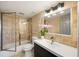 Bathroom featuring a modern vanity, large mirror, and tiled tub-shower combo at 795 Hammond Dr # 1707, Atlanta, GA 30328