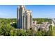 Stunning exterior view of two high-rise condo buildings nestled among lush green trees at 795 Hammond Dr # 1707, Atlanta, GA 30328