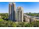 Exterior shot showcasing two modern high-rise condos with city views and lush greenery at 795 Hammond Dr # 1707, Atlanta, GA 30328