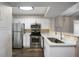 Well-lit kitchen with stainless steel appliances, white cabinets, and modern finishes at 795 Hammond Dr # 1707, Atlanta, GA 30328