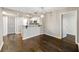 Cozy living space with hardwood floors, breakfast bar, and modern lighting fixtures at 795 Hammond Dr # 1707, Atlanta, GA 30328