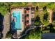 Aerial view of a luxurious community pool with seating, sunshades, and lush landscaping at 795 Hammond Dr # 1707, Atlanta, GA 30328