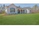 Spacious backyard with white brick home and covered patio at 103 Candler Loop, Acworth, GA 30101