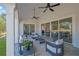 Relaxing covered patio with ample seating, ceiling fans, and sliding glass doors at 103 Candler Loop, Acworth, GA 30101