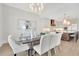 Dining area featuring abundant natural light, a contemporary light fixture, and kitchen views at 103 Candler Loop, Acworth, GA 30101