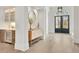 Grand foyer with light hardwood floors, decor, a dry bar, and an arched doorway at 103 Candler Loop, Acworth, GA 30101