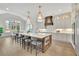 Gourmet kitchen with island seating and stainless steel appliances, flowing into a formal dining area at 103 Candler Loop, Acworth, GA 30101
