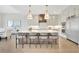 Island kitchen featuring custom cabinets, high-end appliances, a breakfast bar, and modern pendant lights at 103 Candler Loop, Acworth, GA 30101