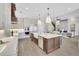 Open kitchen with a large island, stainless steel appliances, and modern lighting at 103 Candler Loop, Acworth, GA 30101