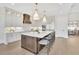 Open gourmet kitchen with a large center island, stainless steel appliances, and modern lighting at 103 Candler Loop, Acworth, GA 30101