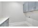 Laundry room features gray cabinets, quartz countertops, and hexagonal tile flooring at 103 Candler Loop, Acworth, GA 30101