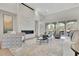 Bright living room with fireplace, large windows, plush seating, and neutral decor at 103 Candler Loop, Acworth, GA 30101
