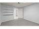 Finished basement with carpet flooring, closet, shelving and door provides extra living space at 1363 Brentwood Ln, Marietta, GA 30062