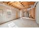 Unfinished basement with exposed beams and window offers room for customization and natural light at 1363 Brentwood Ln, Marietta, GA 30062