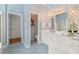 Bright primary bathroom with blue textured walls, dual sinks and walk in closet at 1363 Brentwood Ln, Marietta, GA 30062