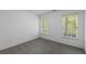 Bedroom features neutral paint, two windows, and carpet flooring at 1363 Brentwood Ln, Marietta, GA 30062