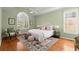This primary bedroom features a tray ceiling, plantation shutters, and a beautiful rug at 1363 Brentwood Ln, Marietta, GA 30062