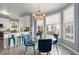 Cozy breakfast nook with a glass table, blue chairs, and a decorative chandelier, next to the kitchen at 1363 Brentwood Ln, Marietta, GA 30062
