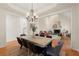 Open concept dining room with modern chandelier, wooden table, and views into the spacious living area at 1363 Brentwood Ln, Marietta, GA 30062