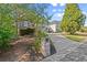 Long driveway leading to a home with stone accents, landscaping and a mailbox with the house number at 1363 Brentwood Ln, Marietta, GA 30062